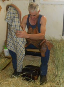 Mark Porter stuffing a long-straw collar rim in the Collar Bin.  The straw used is cereal rye, or rye-corn (Secale cereale)